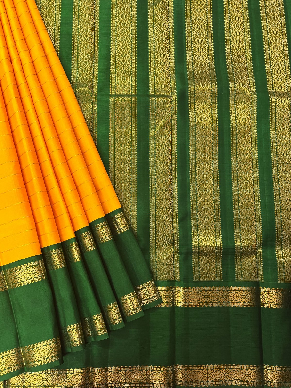 dark green saree with yellow border