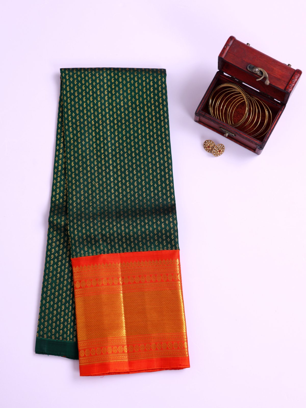 Bottle Green Kanjeevaram Silk Pavadai With Reddish Orange Border