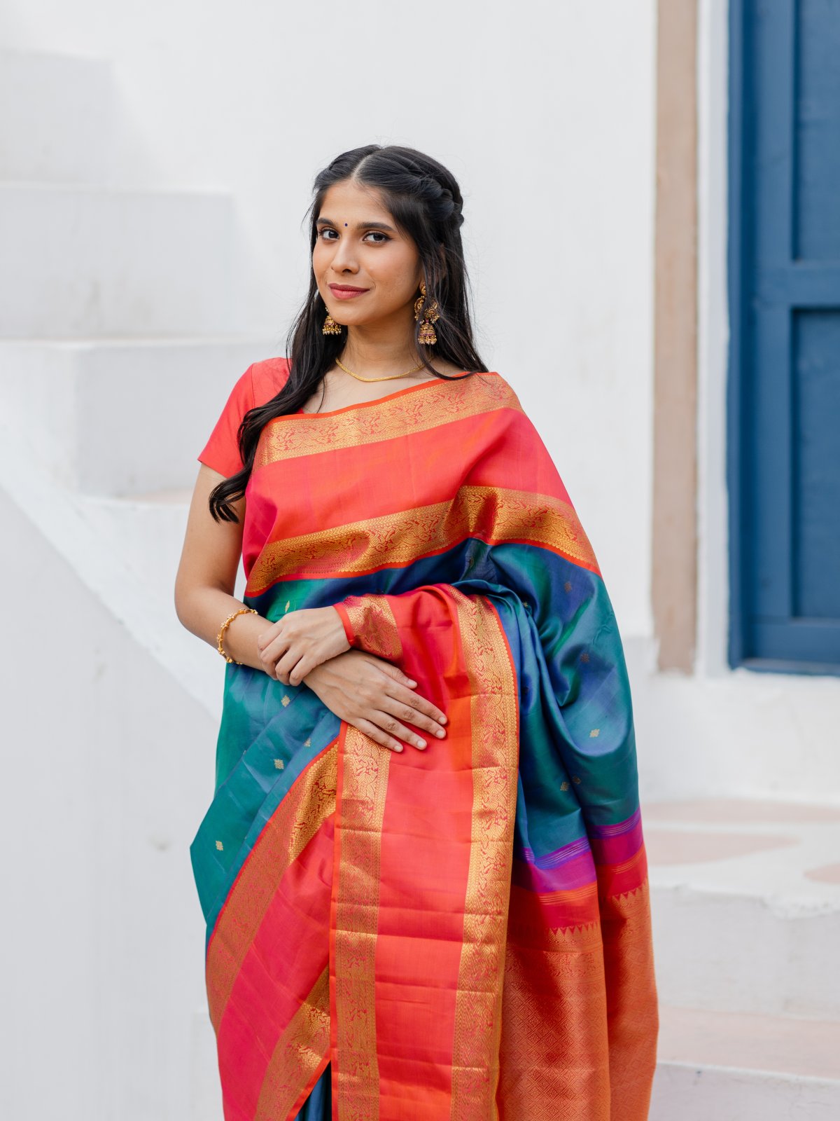 Orange semi-uppada saree features floral buttas, plain border & contrast  pallu of intricate paisleys